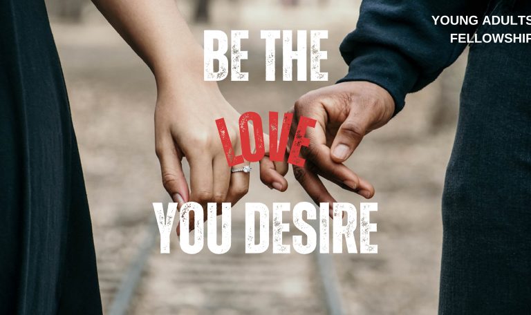 A man and woman stand with pinkie fingers interlocked